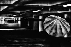 The woman with the umbrella (203);.....in the parking garage....