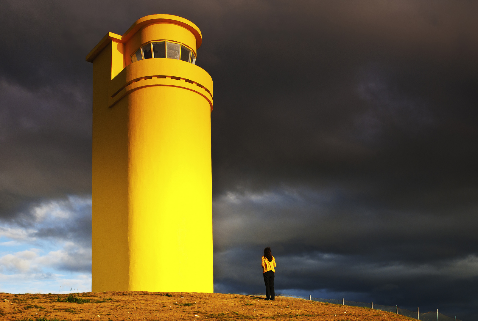 The yellow lighthouse and the tourist