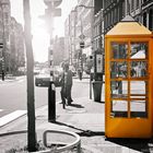 This is a yellow phone booth