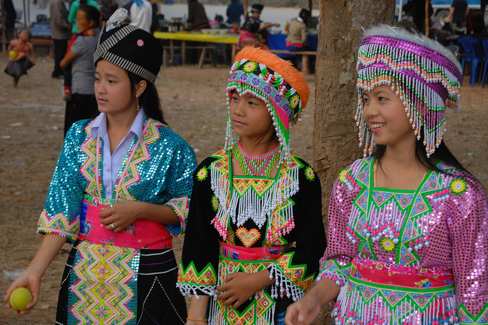 Three Hmong girls in different costumes near Luang Prabang