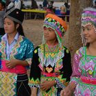 Three Hmong girls in different costumes near Luang Prabang