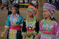 Three Hmong girls in different costumes near Luang Prabang