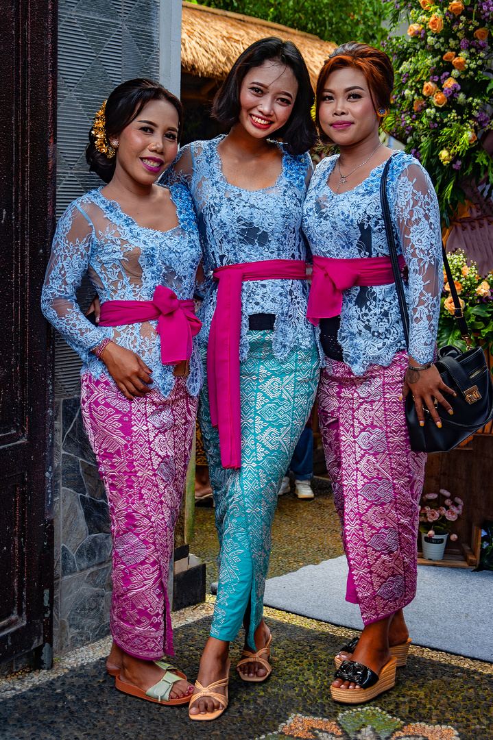 Three ladies welcome wedding guests