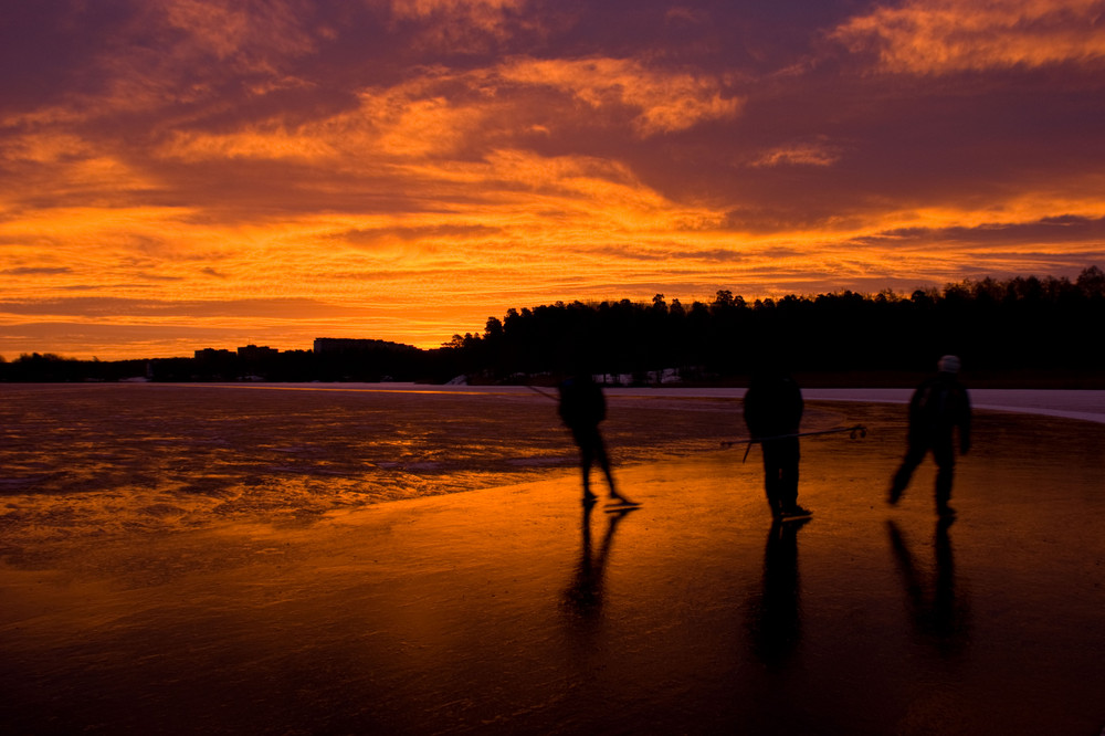 Three skaters in the sunrise