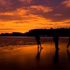 Three skaters in the sunrise