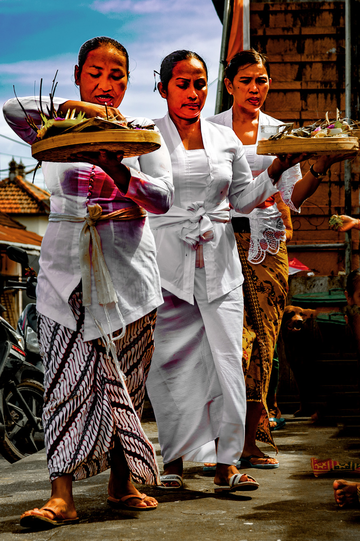 Three women sacrifice their offerings