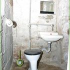Toilettenraum aus der Nachkriegszeit mit neuzeitlicher Klobürste