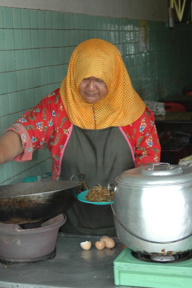 TORTOISE SHELL BORNEO WOMAN COOKING AT ROADSIDE CAFE