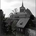 Turm auf Haus auf Haus neben Mauer