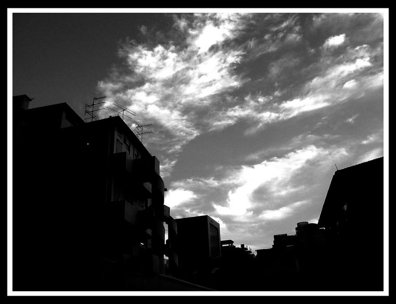 twirling clouds over the suburbanscape