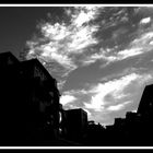 twirling clouds over the suburbanscape