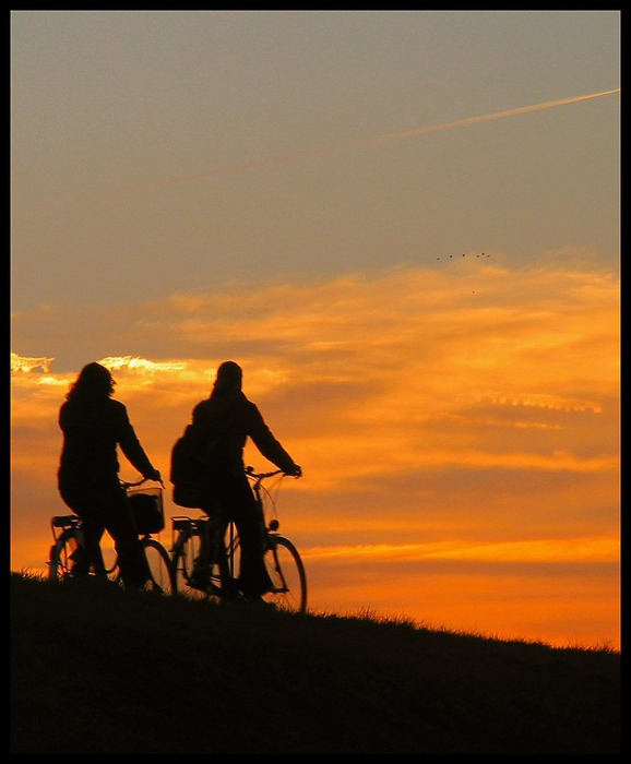 Two girls bicycling home