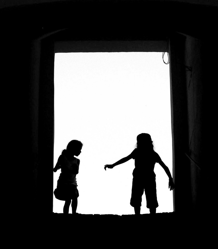 Two girls (silhouetted)