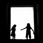 Two girls (silhouetted)
