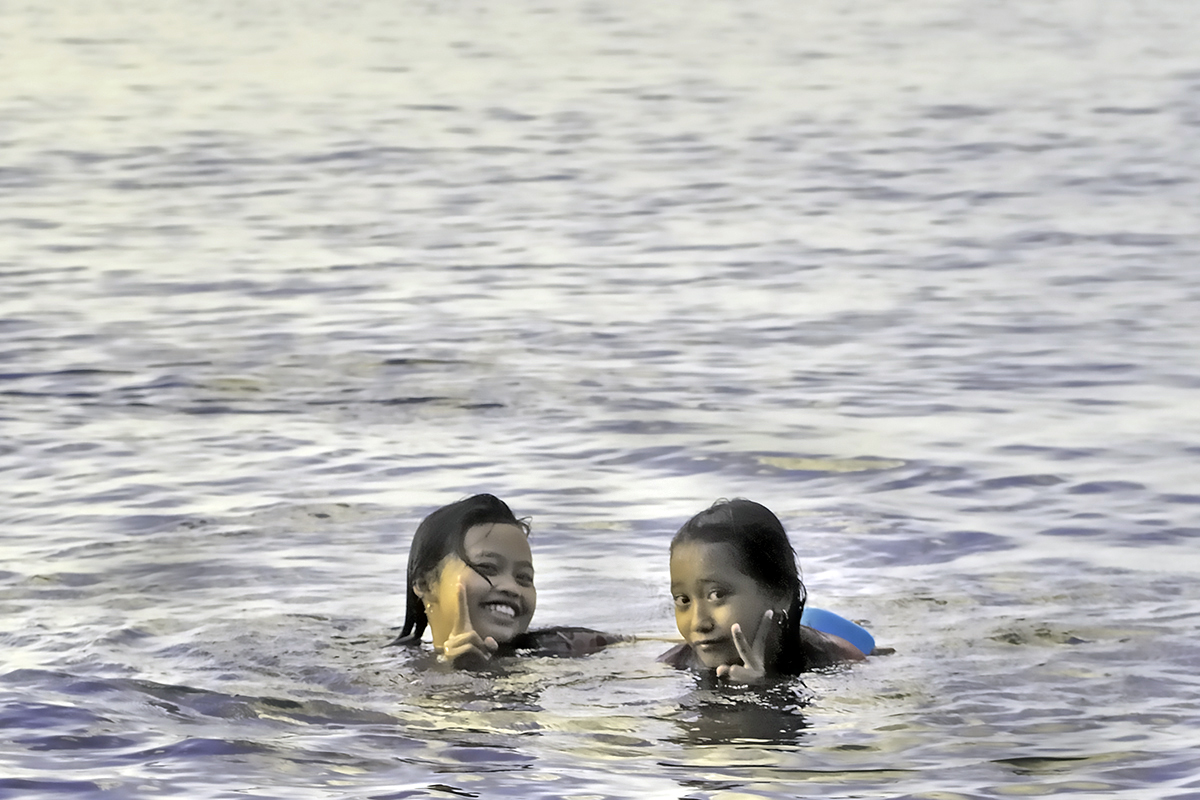 Two kids look out the water surface