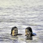 Two kids look out the water surface