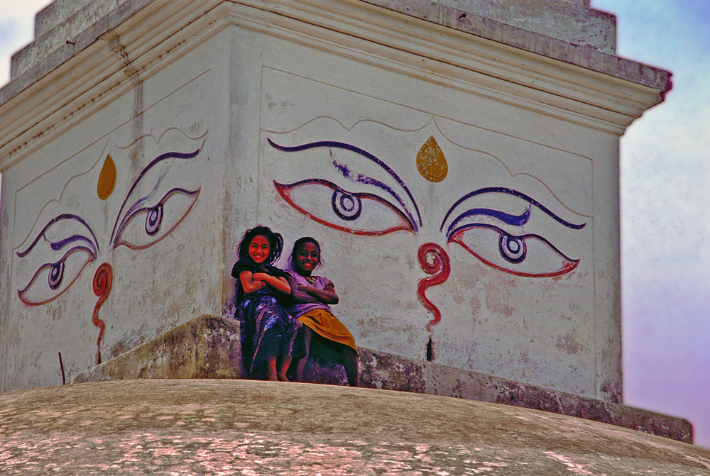Two lovely girls climb the stupa