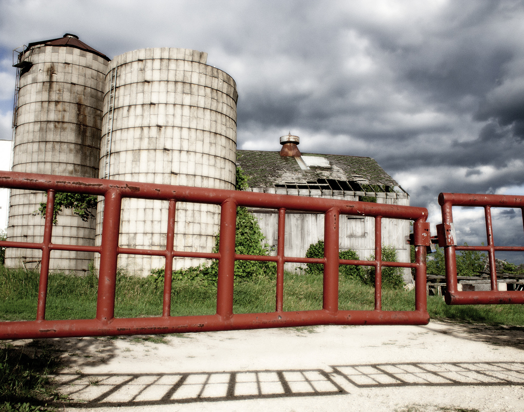 Two Silos, A Barn And Red Gates