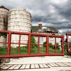 Two Silos, A Barn And Red Gates