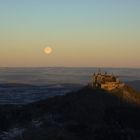 untergehender Vollmond bei aufgehender Sonne