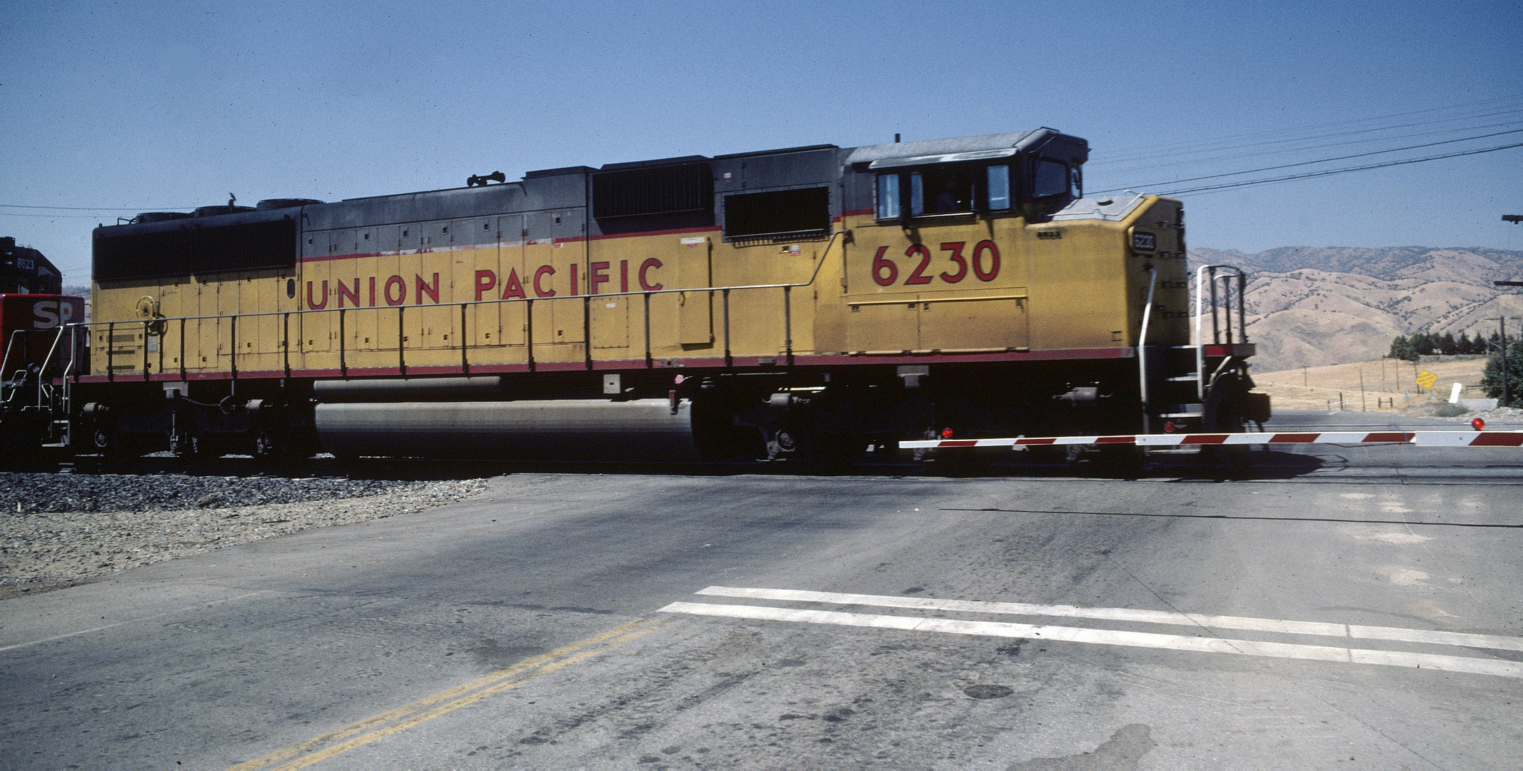 UP#6230, SP#8623 on their way to Tehapachi Loop, passing road to Caliente,CA