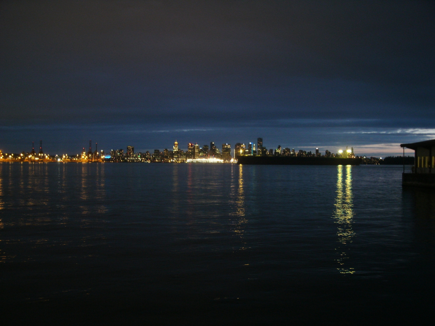 Vancouver Skyline at night with a tanker in the harbour - Burrard Inlet