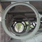 View through cast iron round construction elements of historic Ill river bridge in Strasbourg