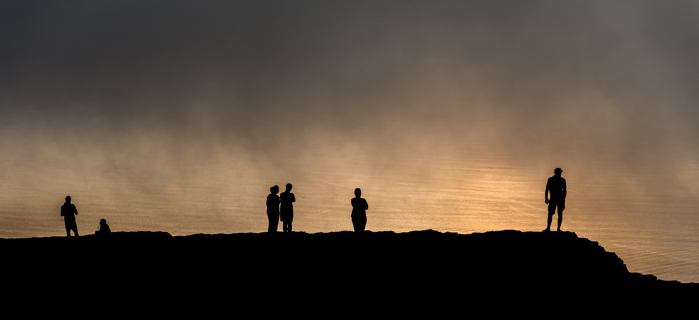 Watching reflection of sunset from cliffs