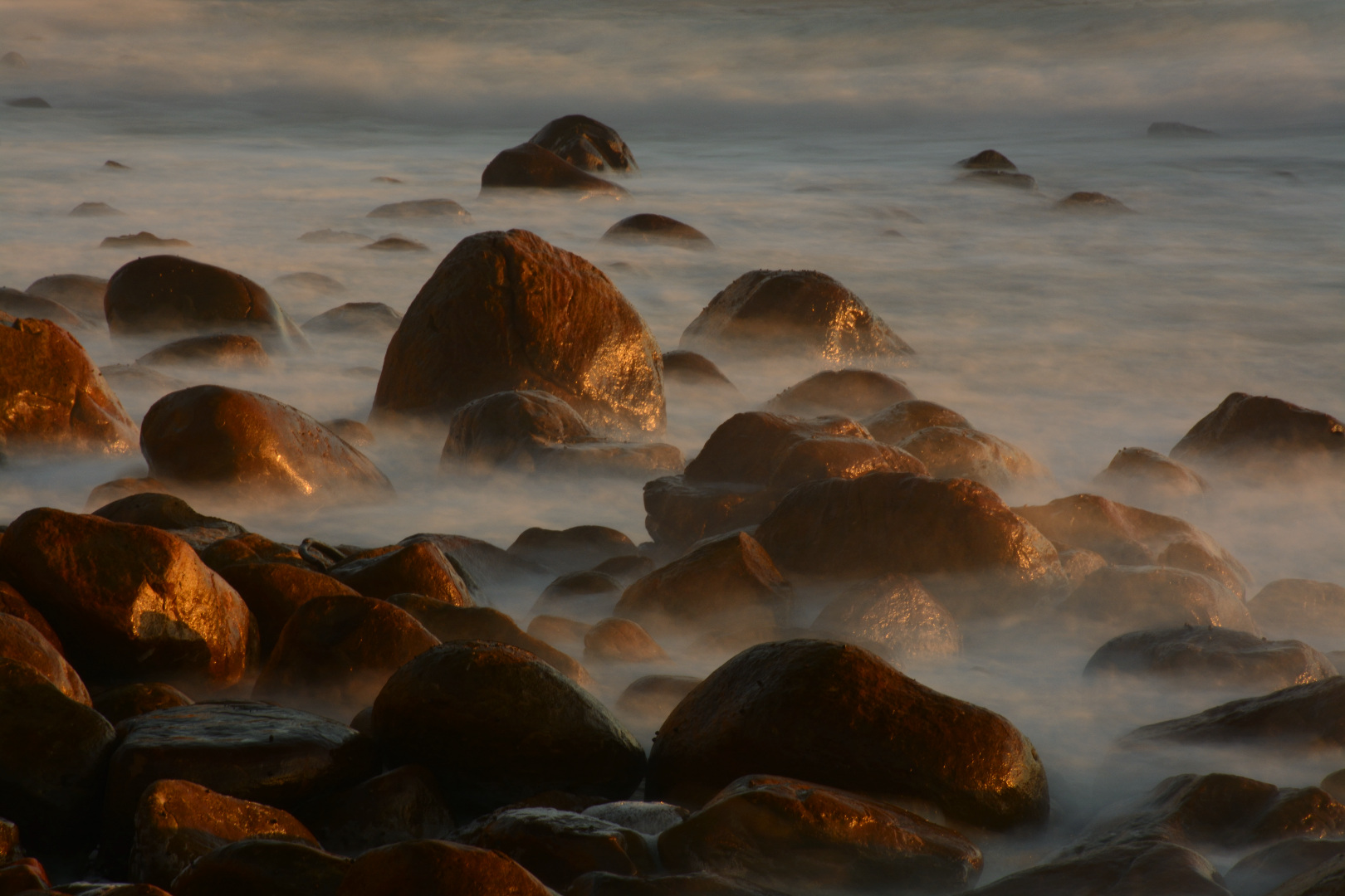 Wet rocks and a smooth sea