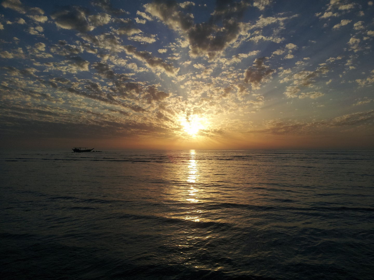 When the sun was drinking from the sea, a boat was sitting and watching