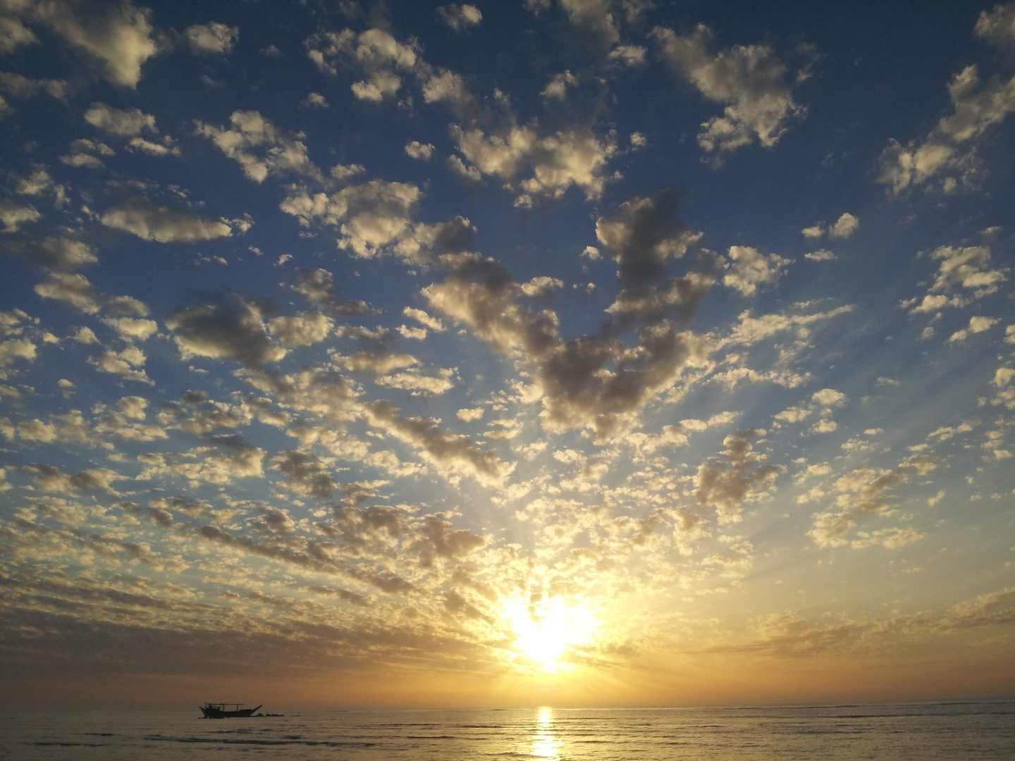 When the sun was drinking from the sea, a boat was sitting and watching