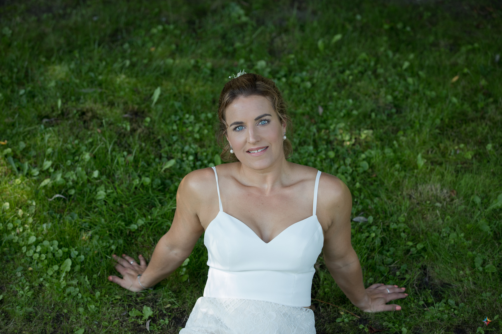 White bride with blue eyes on green grass