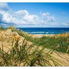 white sand body under a  high blue sky