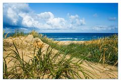 white sand body under a  high blue sky