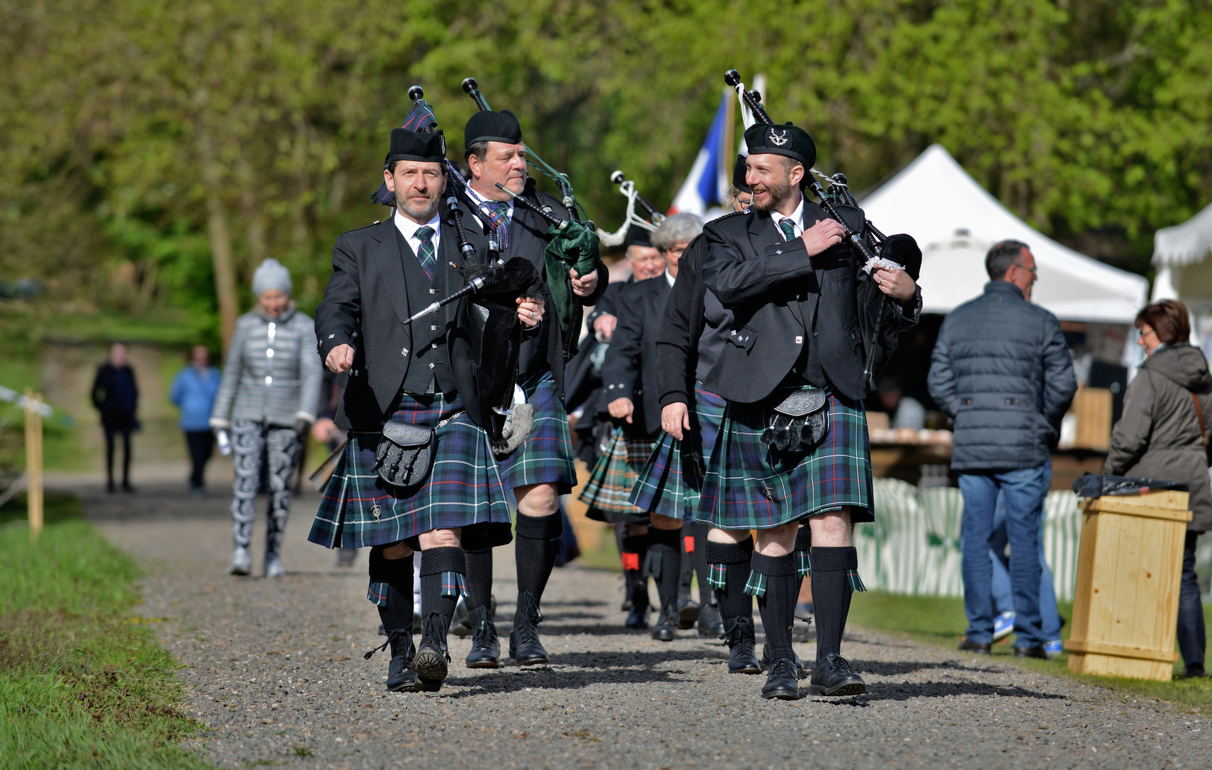 Why do bagpipers walk when they play ?