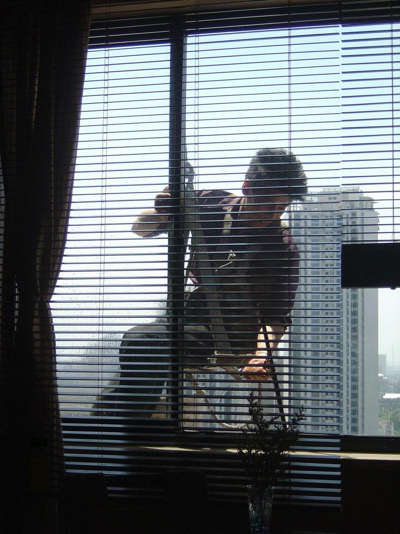 WINDOW CLEANER IN MY HOTEL ROOM ON THE 22 ND FLOOR.