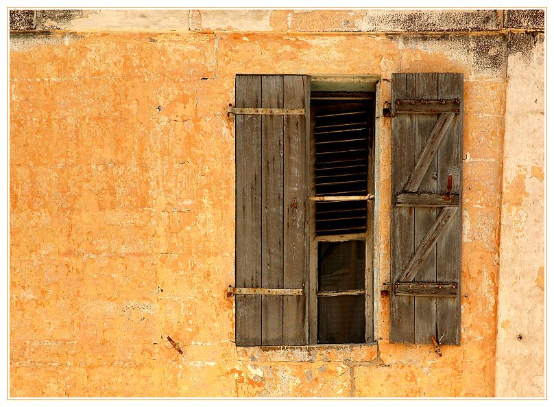 window on ochre wall