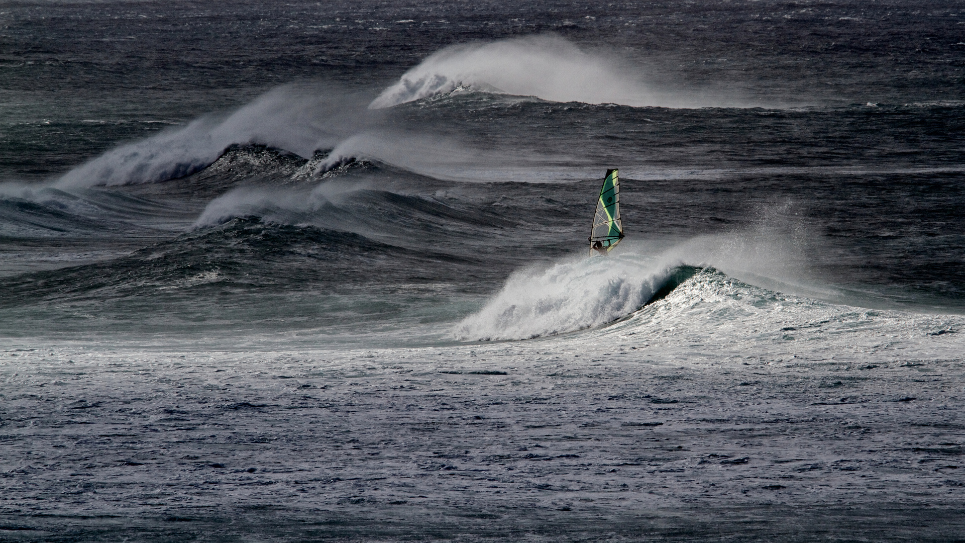 Windsurfer on stormy waters