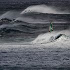 Windsurfer on stormy waters