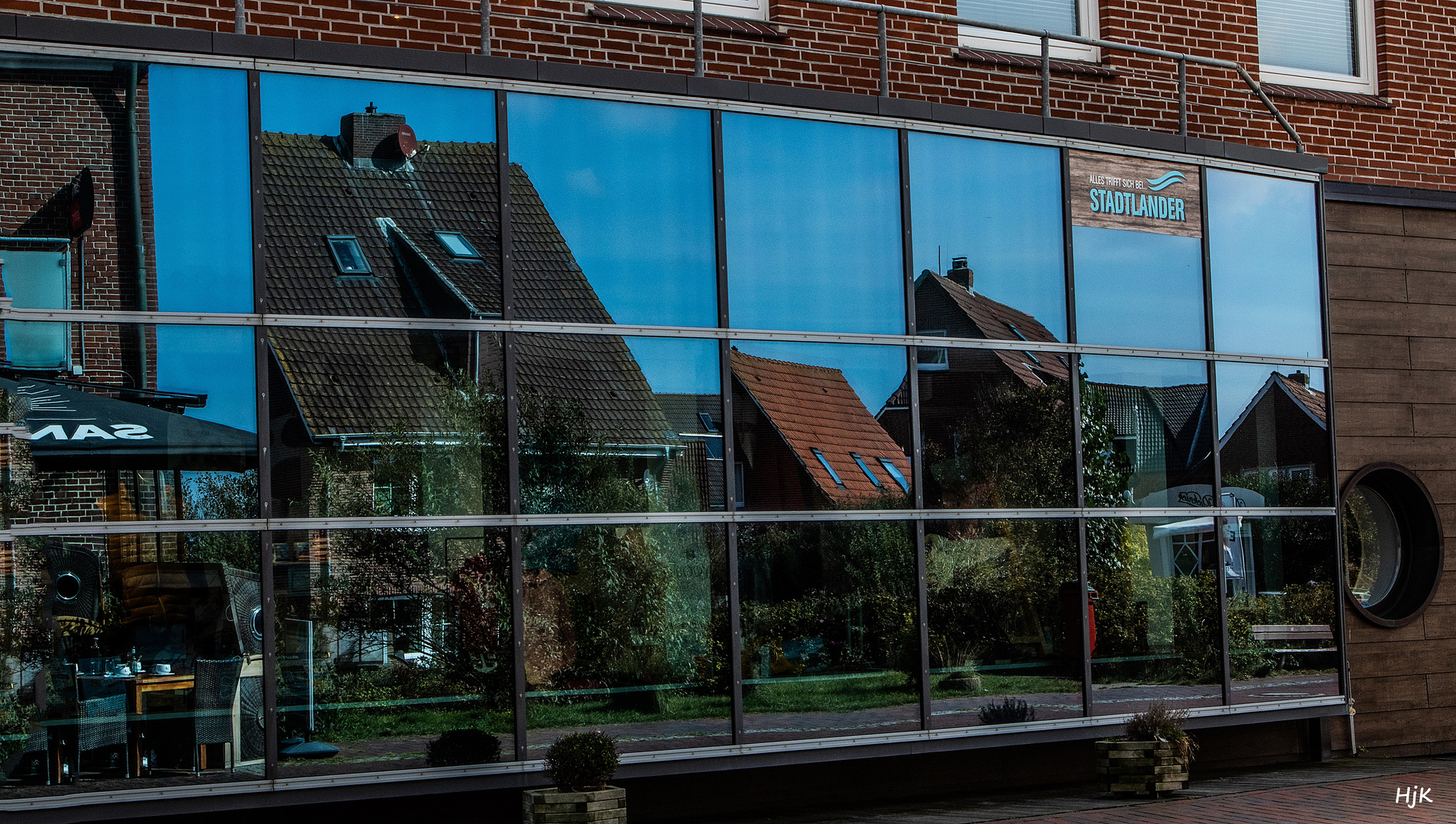 Wohnhäuser gespiegelt in den Schaufenstern des .Stadtlander