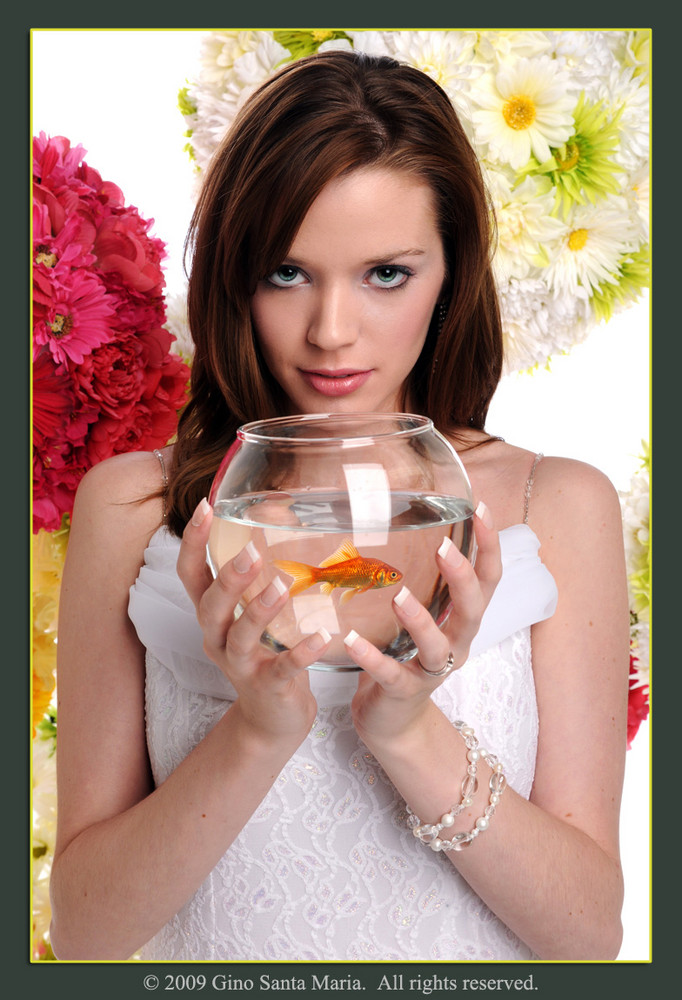 Woman Holding Fishbowl With Goldfish