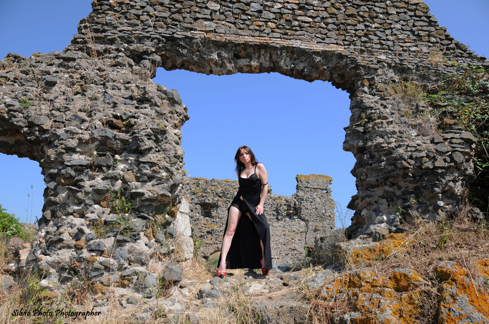 woman in black among the ruins