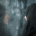 Woman in front of rainy window