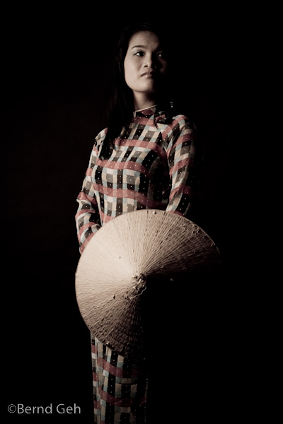 Woman in traditional Ao Dai and straw hat