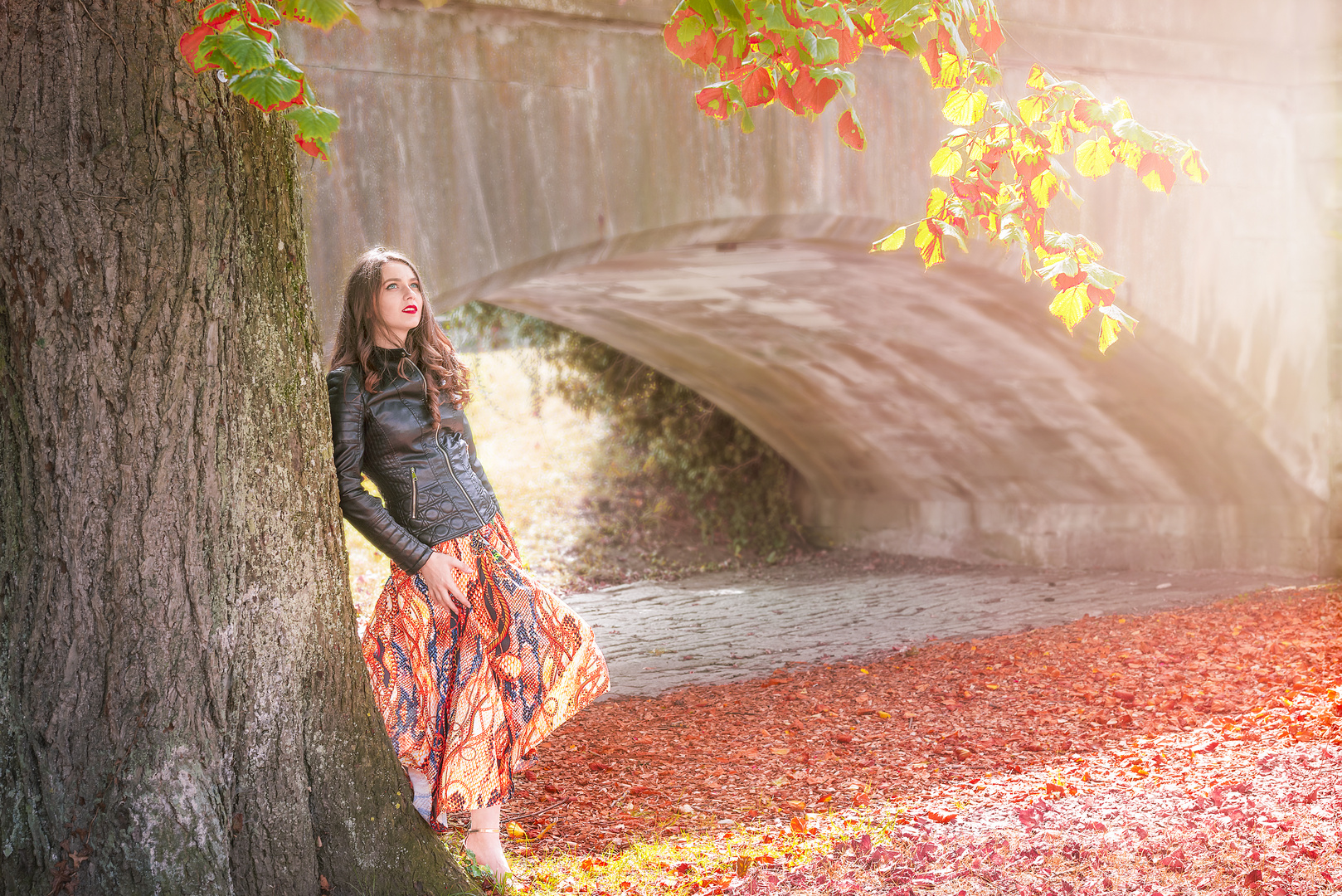 Woman leaning on a tree in autumn colors