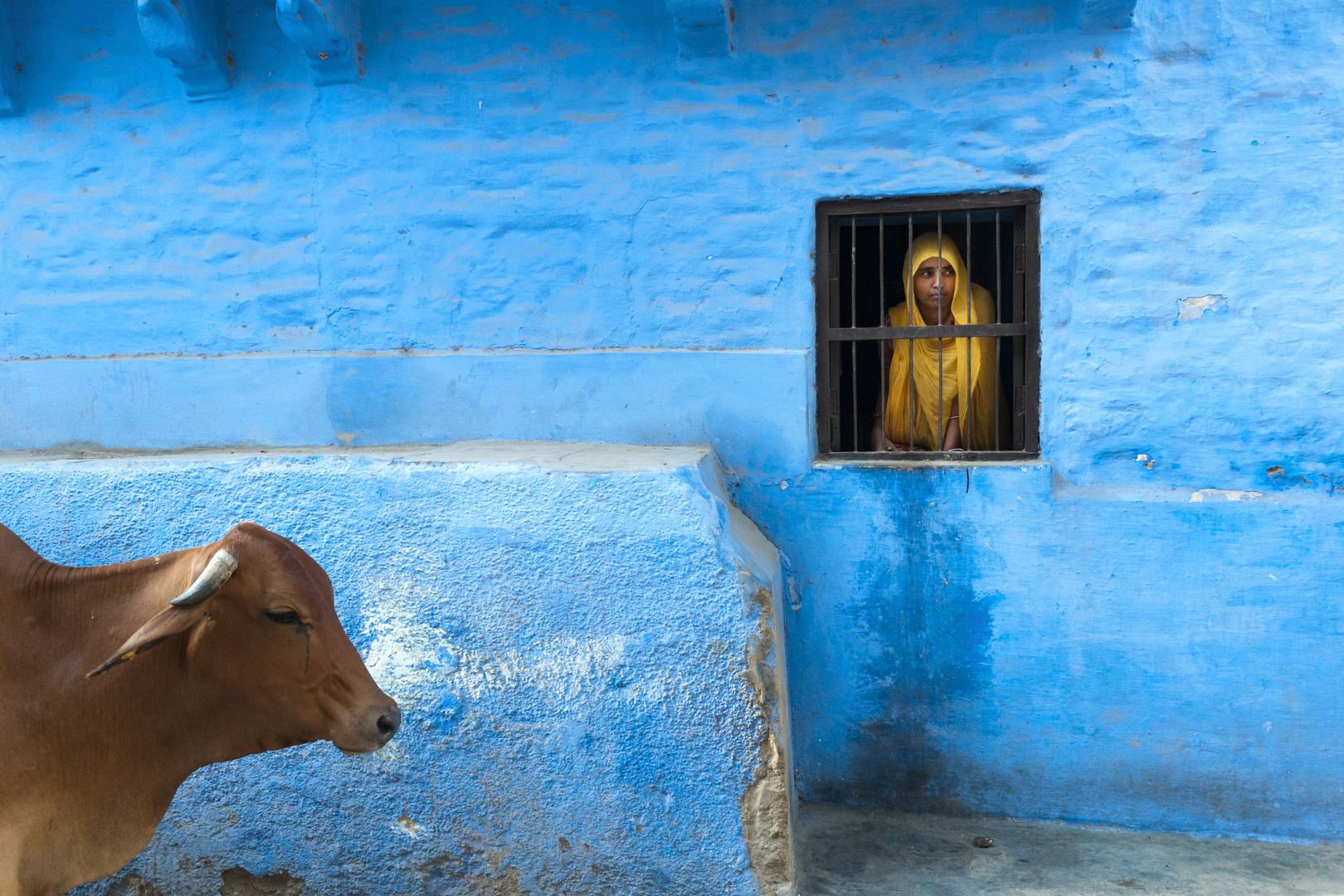 Woman looking from her window