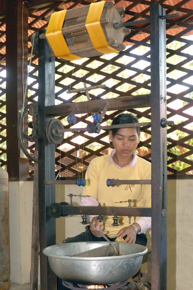 Woman spinning the silk thread