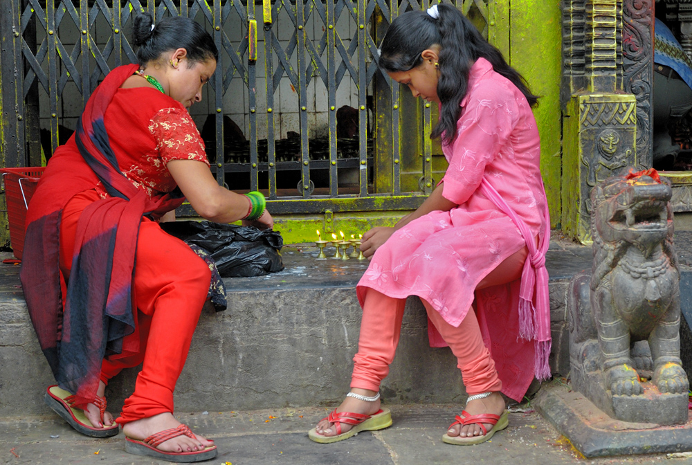 Women give their donation lamps