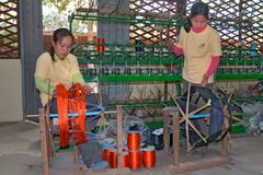 Women spinning thread to make it smooth