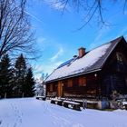 Wooden Cottage in Winter